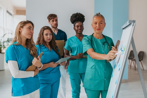 A nurse practitioner discusses some new patient care strategies with the nursing team.